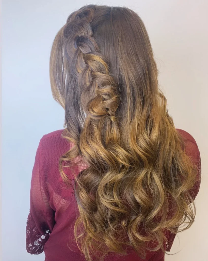 Side braid into wavy ponytail hairstyle
