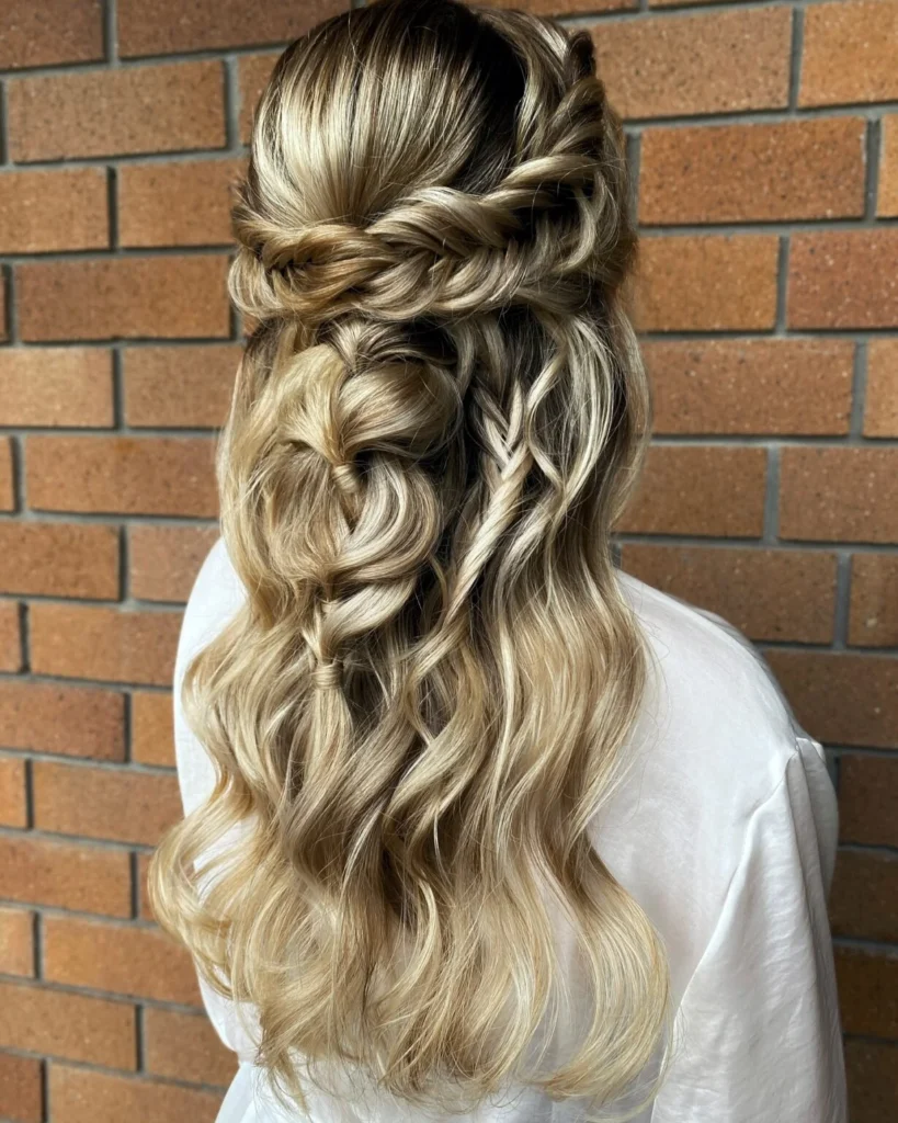 Heart-shaped blonde half-up braid with rope twists, fine accent braids and gentle waves.