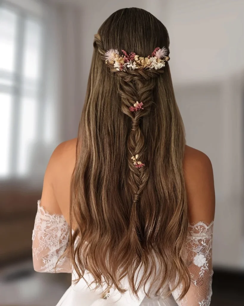 Minimal half-up centre braid decorated with cream and dusty pink dried flowers.