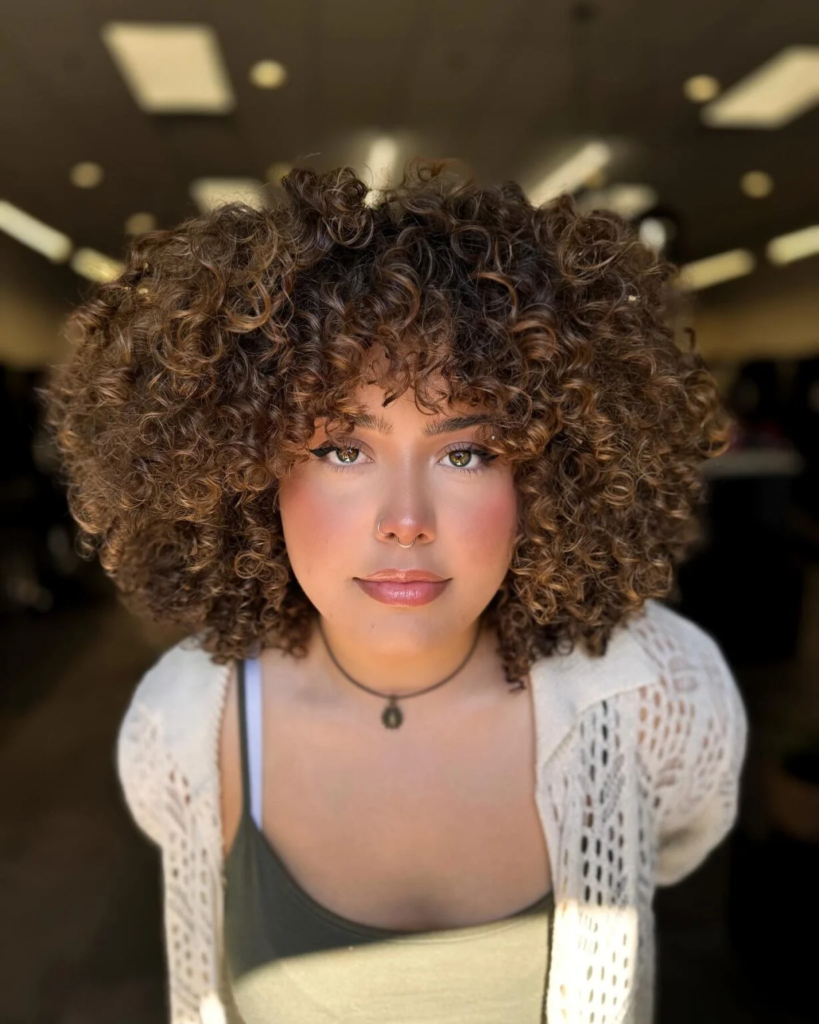 Big curly halo cut with dimensional highlights