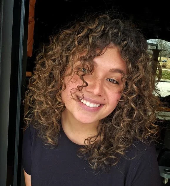 Highlighted curly shag with airy curly bangs