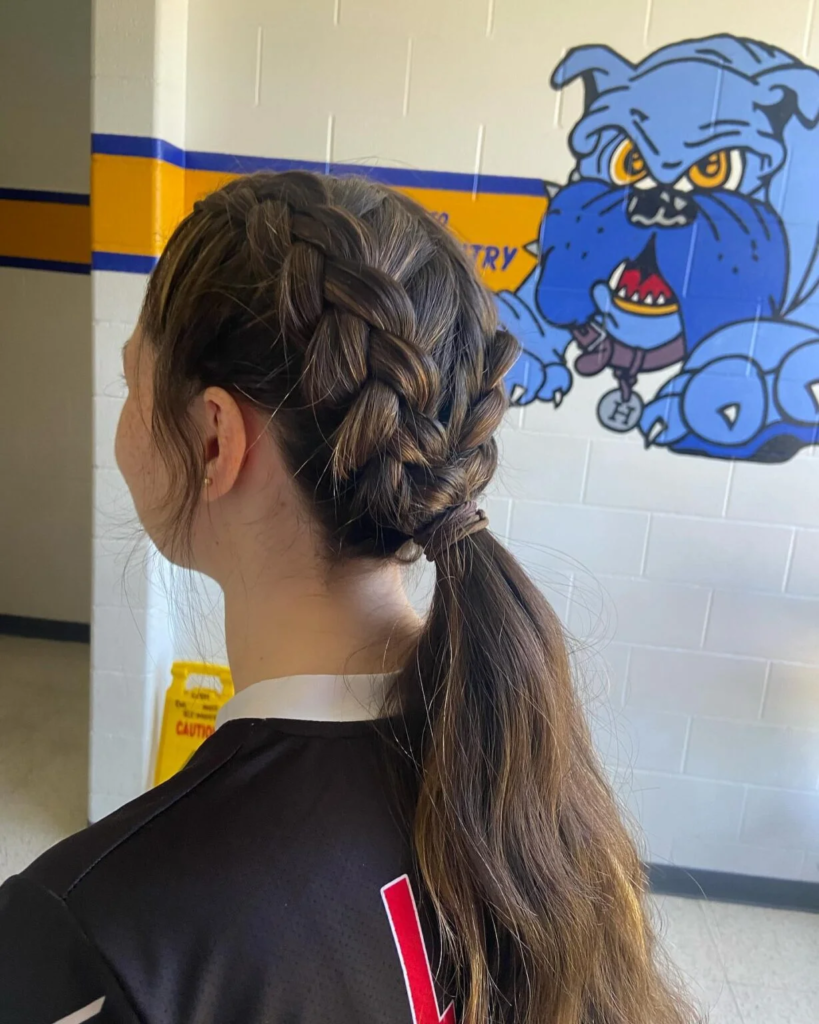 Sporty double Dutch braids gathered into a low ponytail