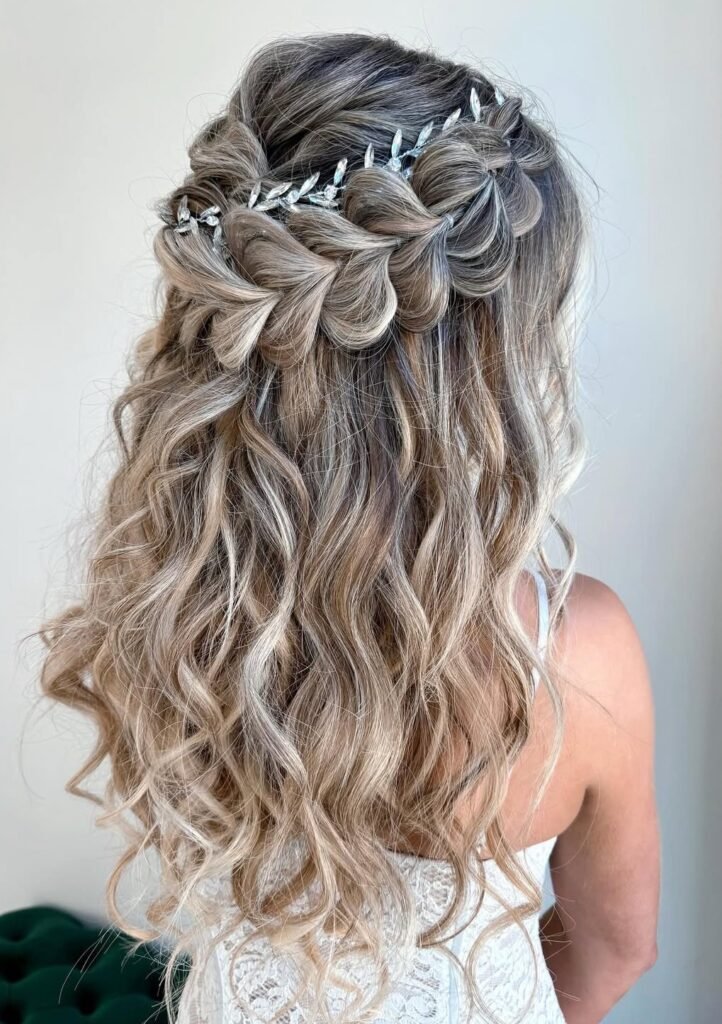 Crystal hair vine woven through a looped half-up braid with long blonde curls