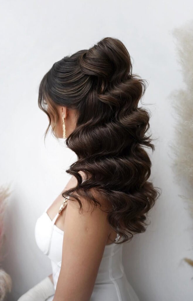 High half-up ponytail with sculpted dark brown waves and face-framing strands