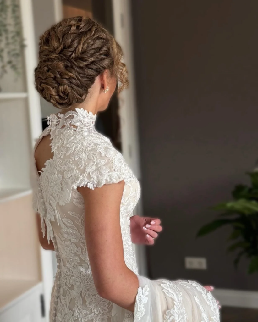 Intricate bridal braided bun with multiple crown braids and a rounded low updo