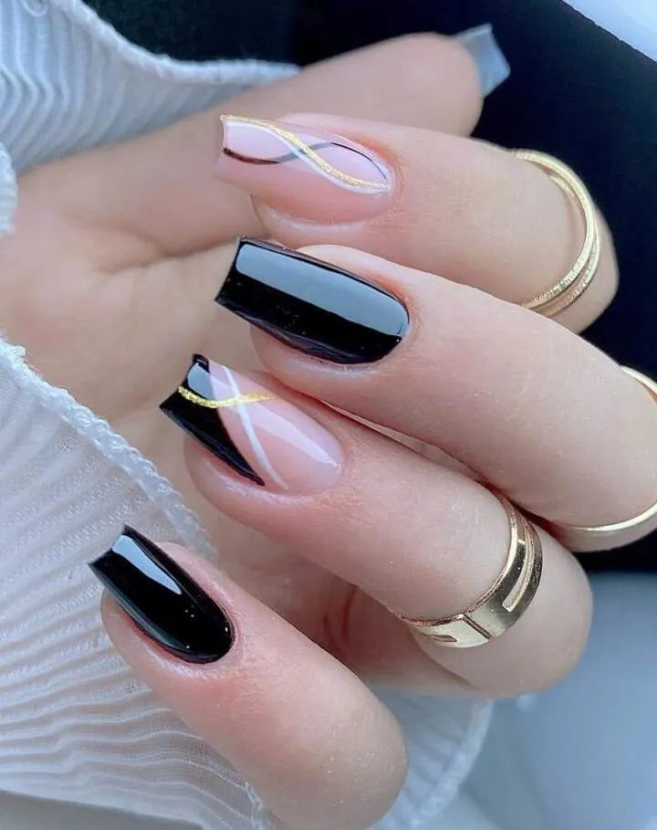 Black square nails with nude accents and fine gold and white curves