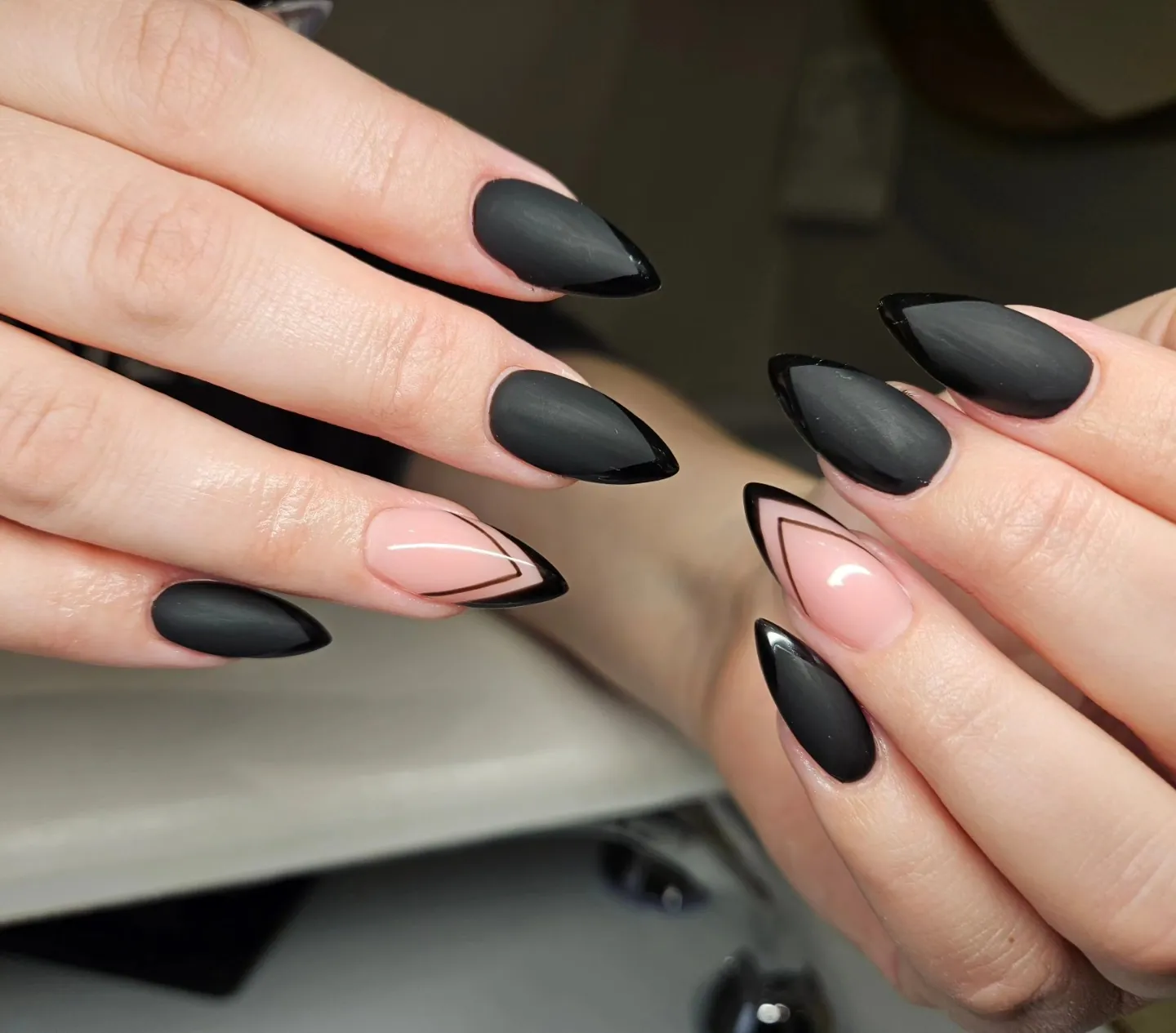 Matte black almond nails with nude outlined accent nails