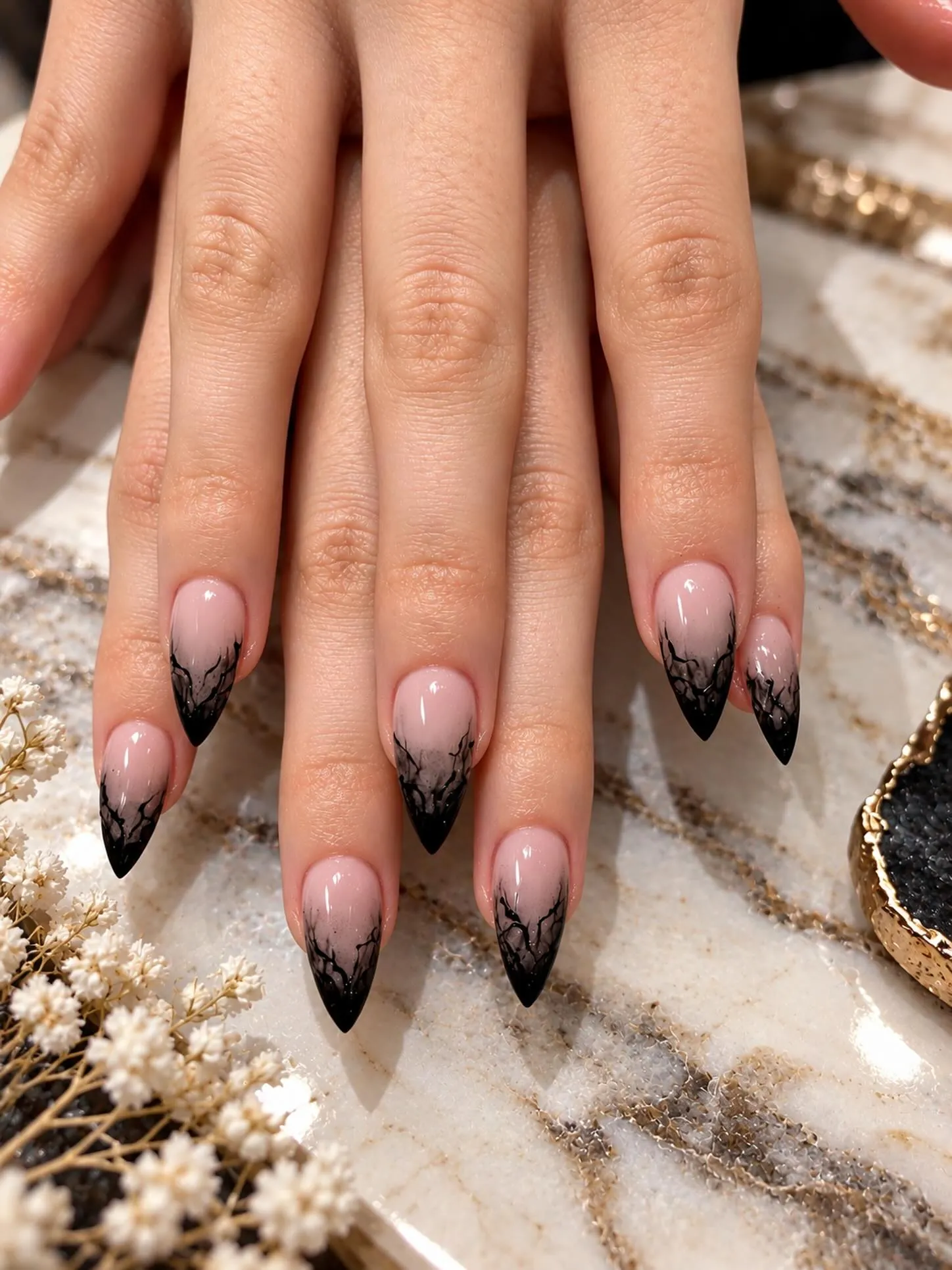 Nude almond nails with black tips and fine branching lines