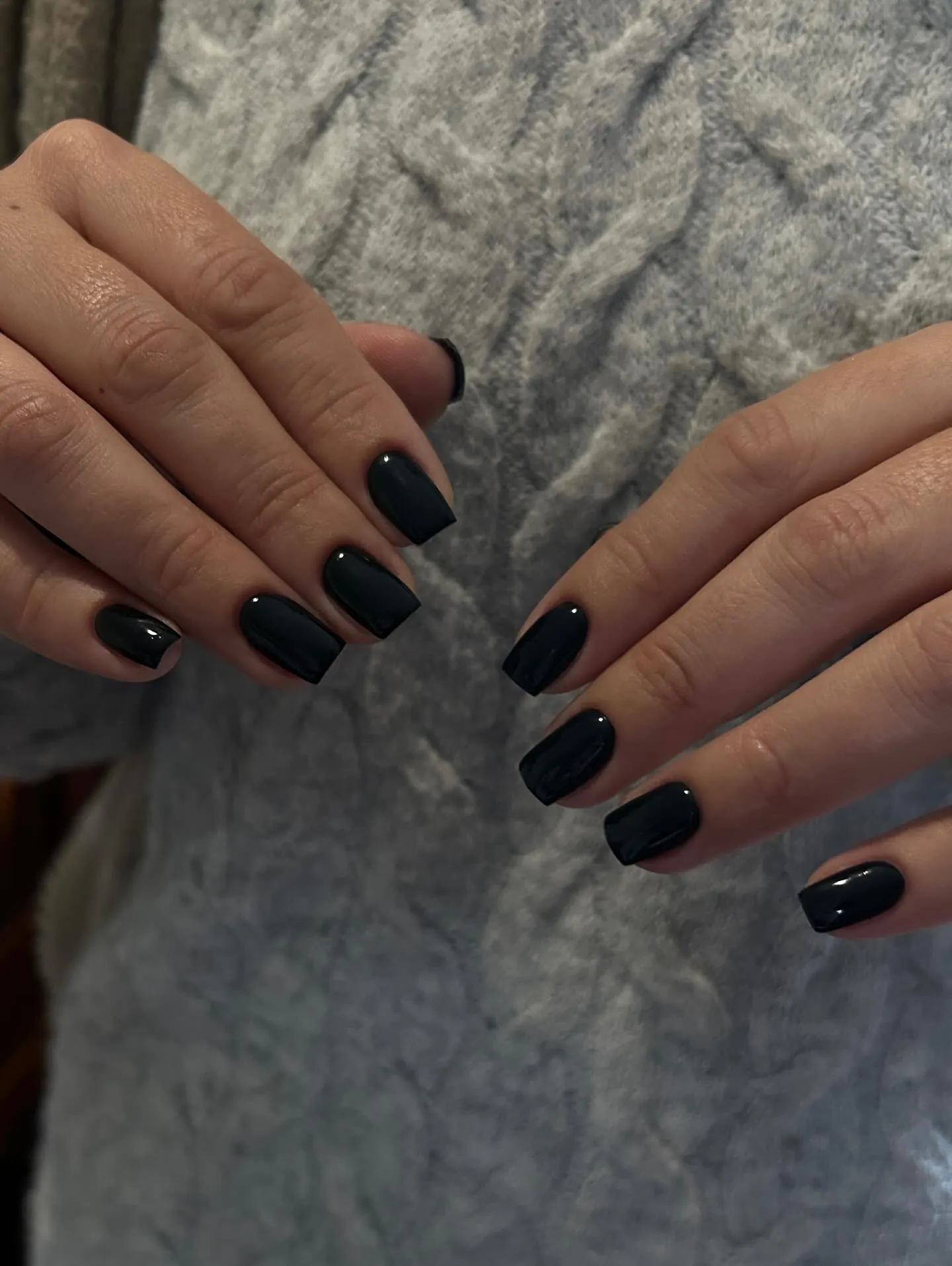 Short black square nails with small metallic accents