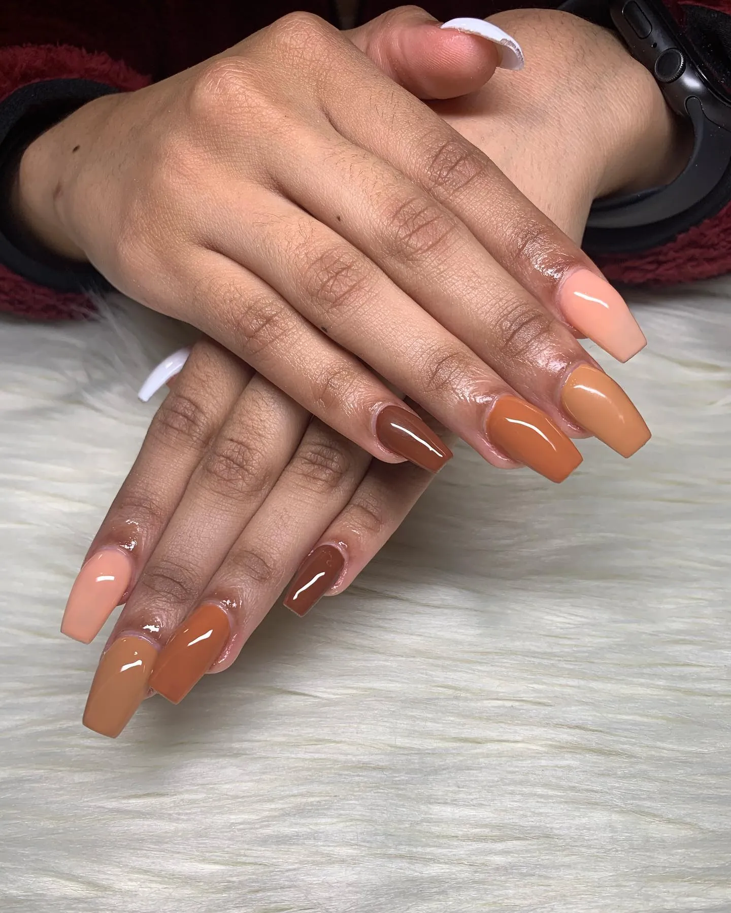 Square nails in solid brown, tan and peach nude shades