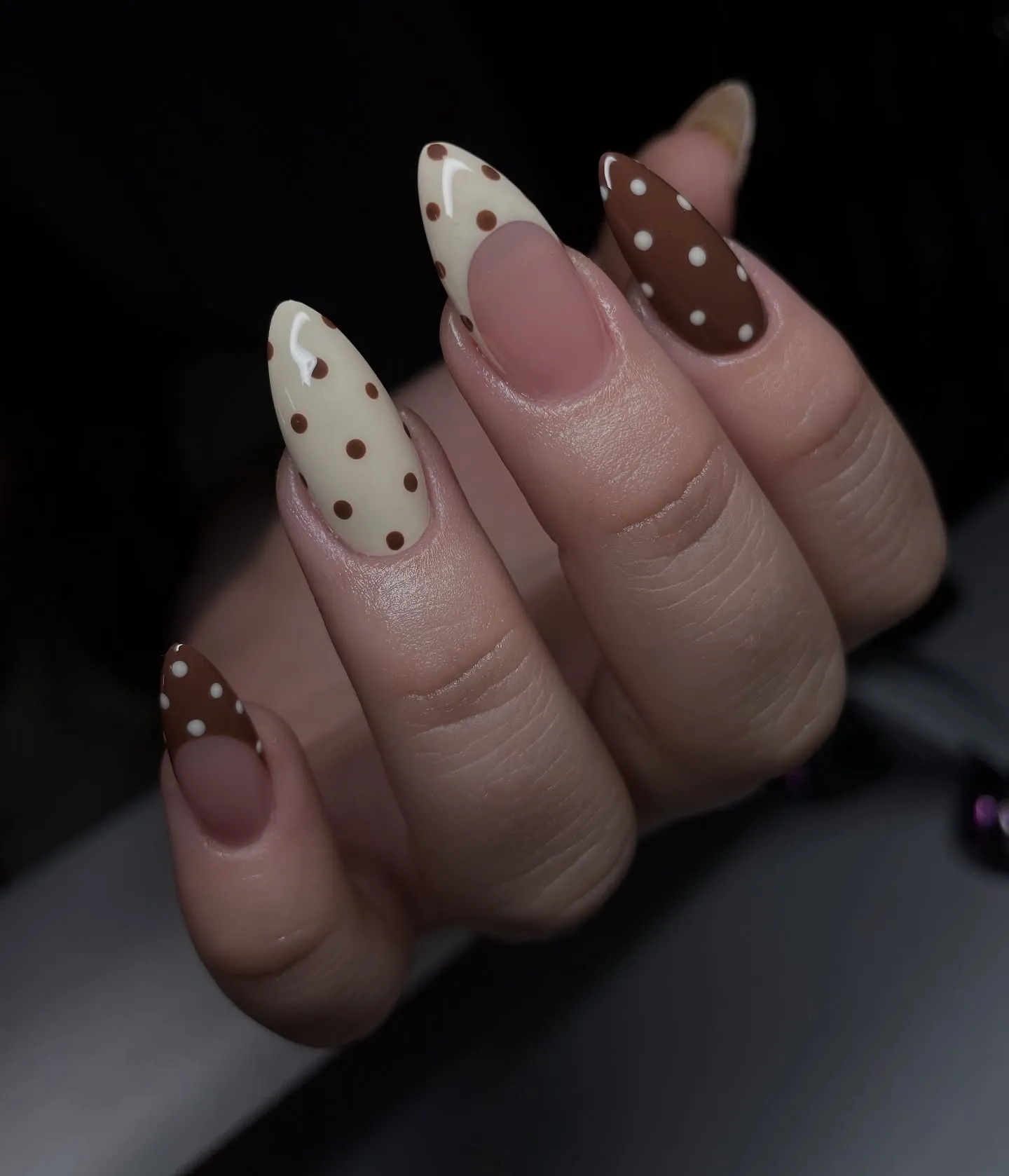 Brown and cream almond nails mixing dotted French tips and fully dotted accents