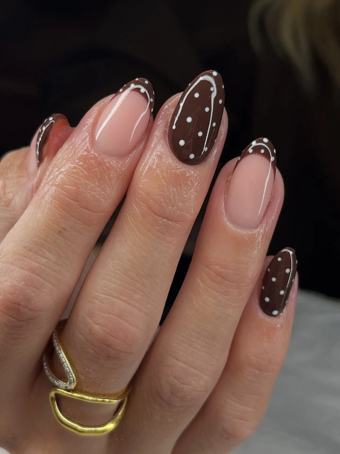 Pink almond nails with dotted brown French tips, brown accents and fine pale outlines