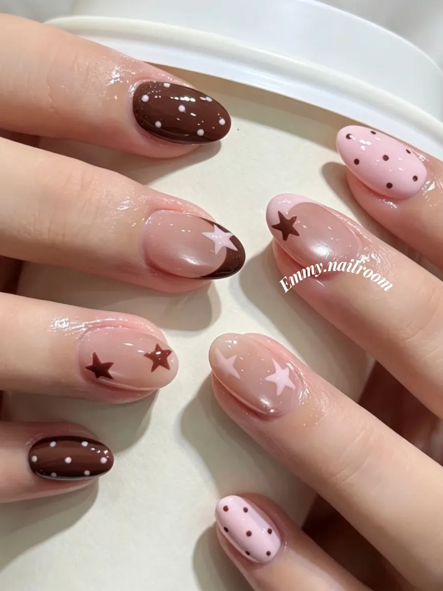 Short pink and brown nails with cocoa dots, French tips and stars