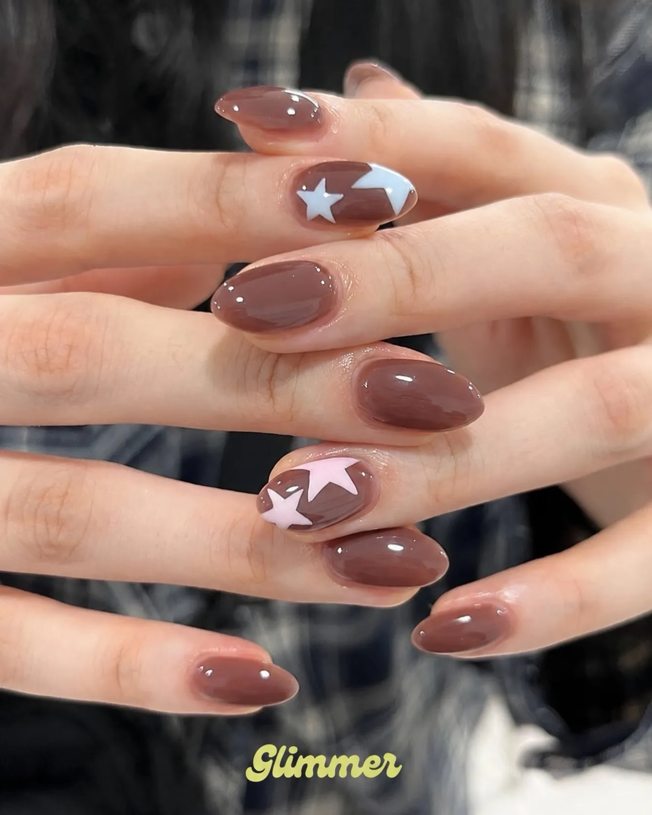 Glossy milk chocolate oval nails with white star motifs