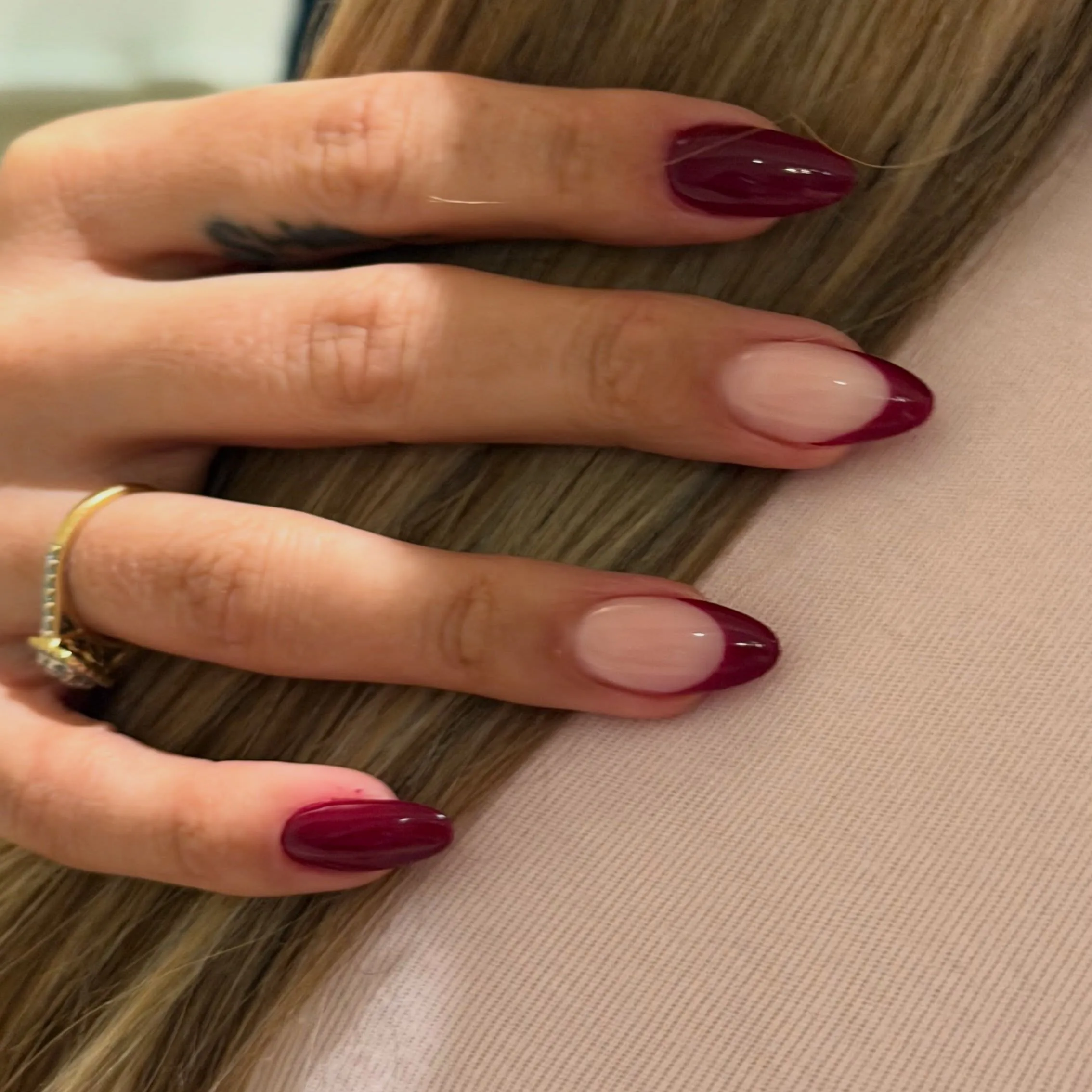 Burgundy almond nails mixing solid polish and nude French accents
