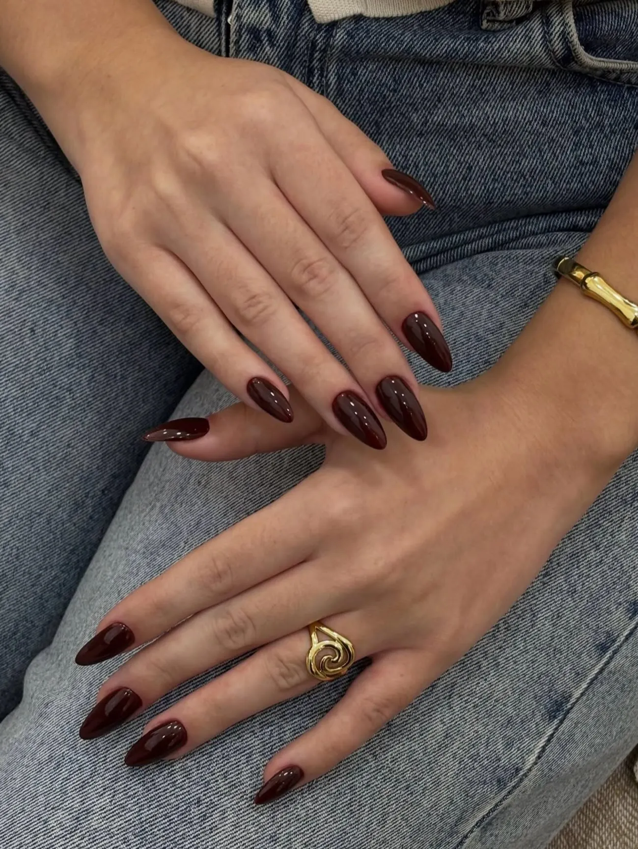 Deep burgundy nails with tapered almond outlines