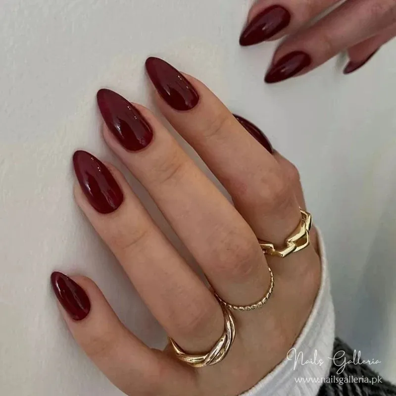 Medium almond nails with smooth glossy burgundy polish