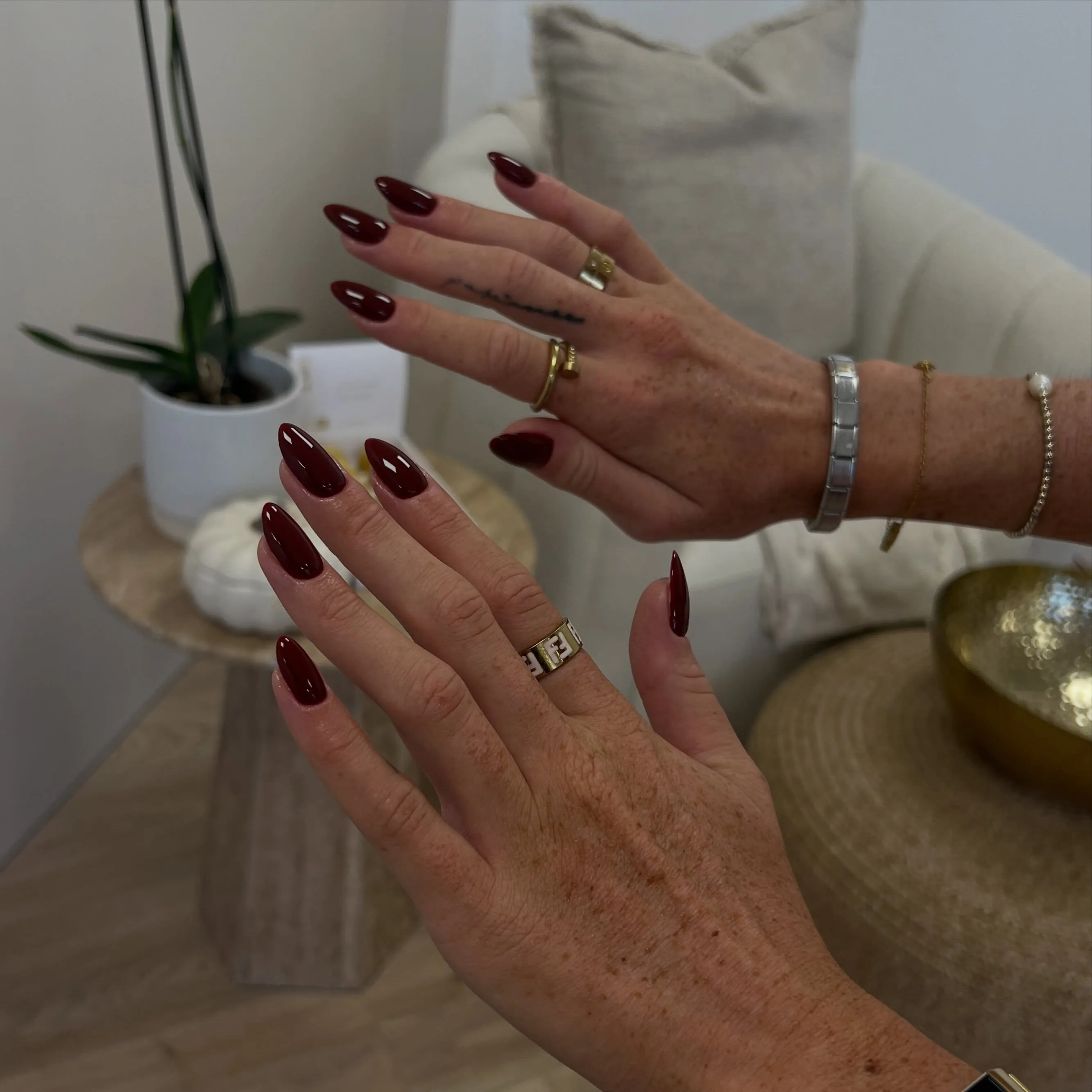 Burgundy nails with rounded almond ends and a glossy surface