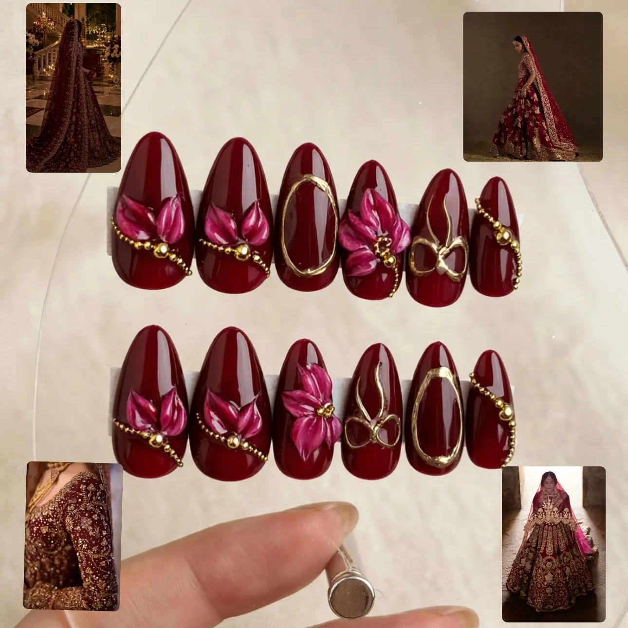 Displayed burgundy nail set with pink raised flowers and gold details