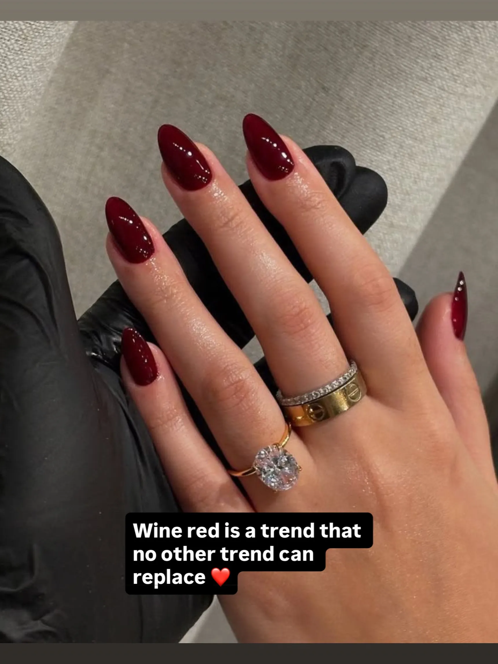 Long almond nails with a glossy wine red finish