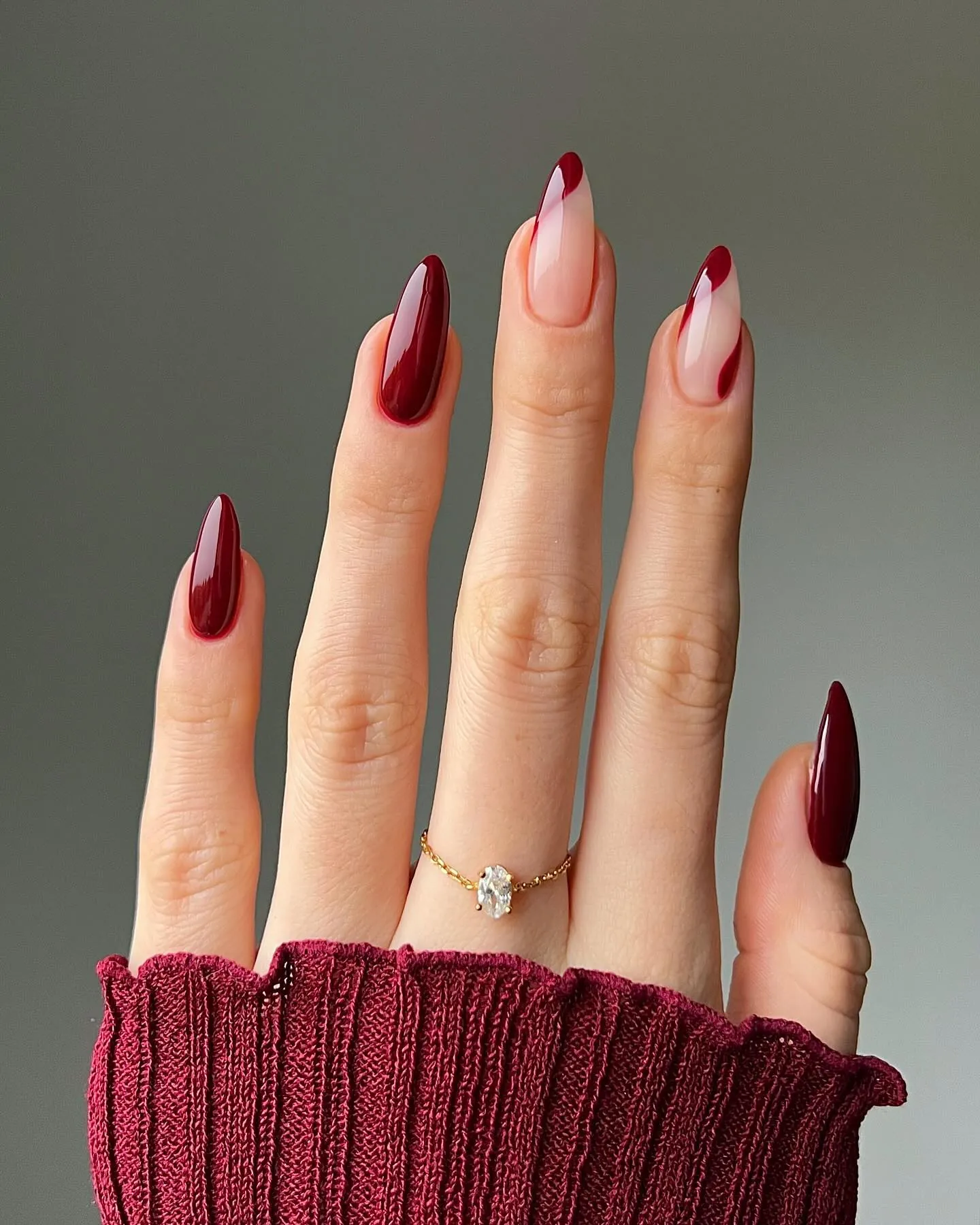 Burgundy almond nails alternating solid color and nude French tips