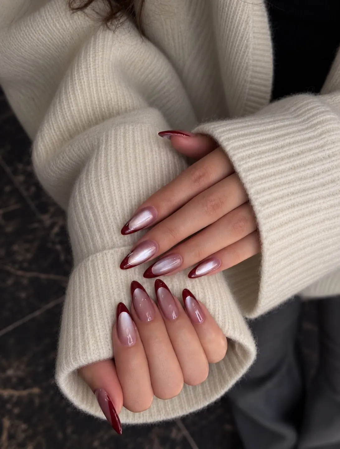 Long tapered almond nails with pink bases and deep burgundy tips