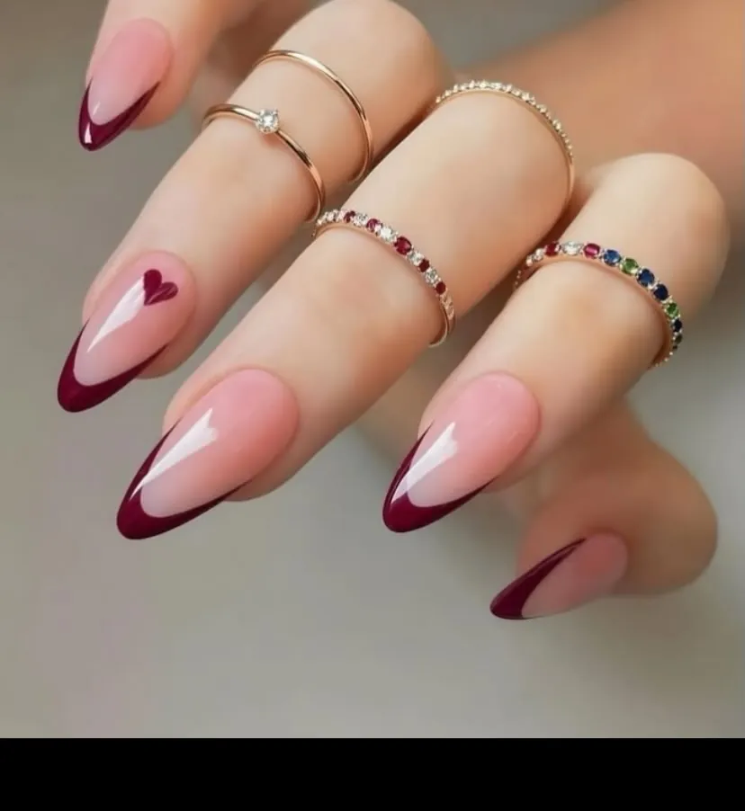 Pink almond French nails with deep burgundy tips and one heart
