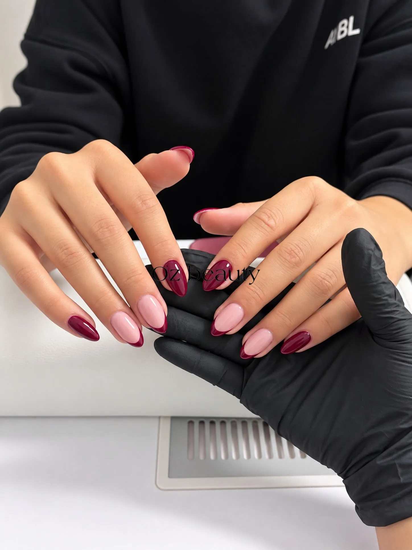 Glossy almond nails mixing burgundy French accents and solid burgundy