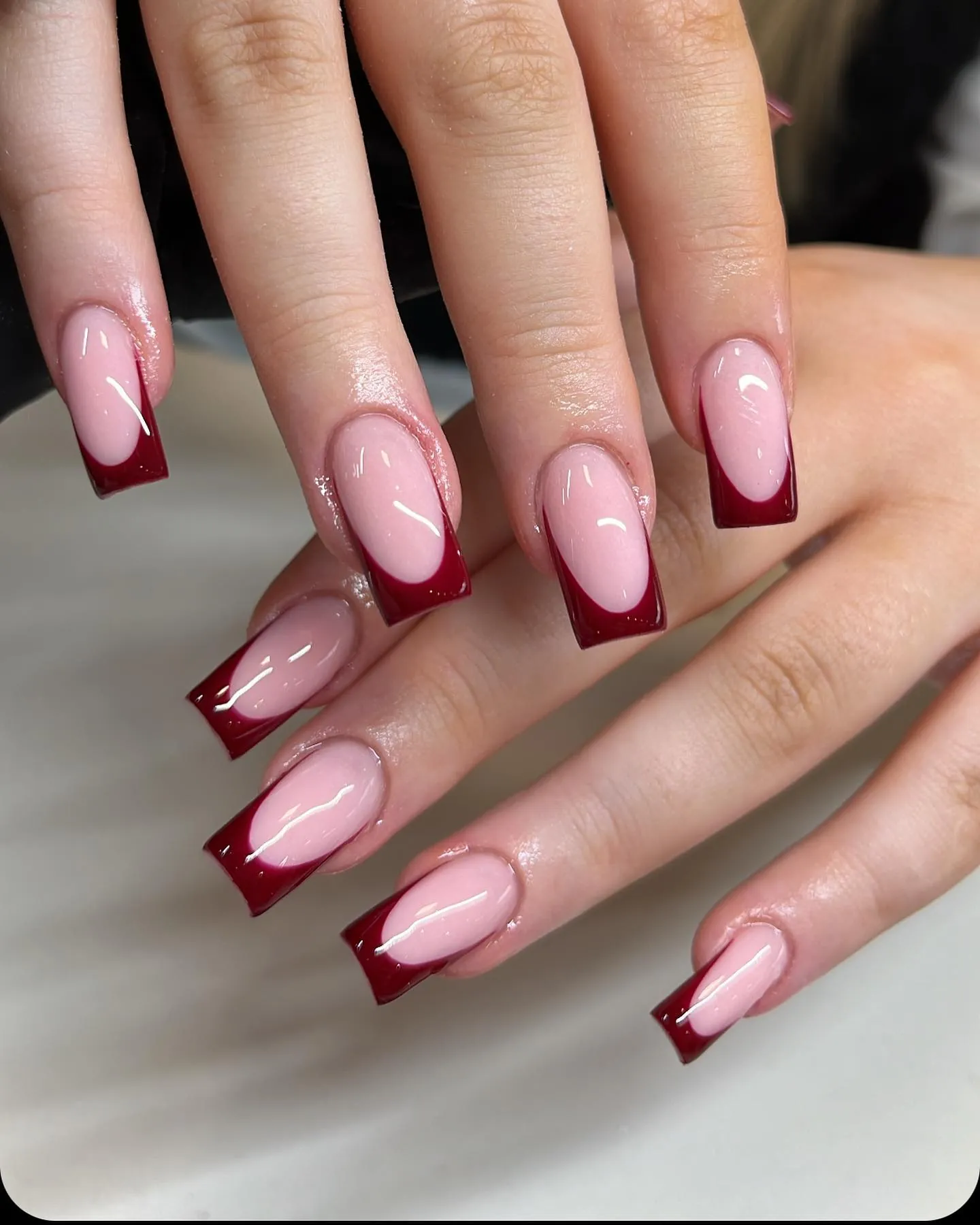 Long square pink nails with deep burgundy French tips