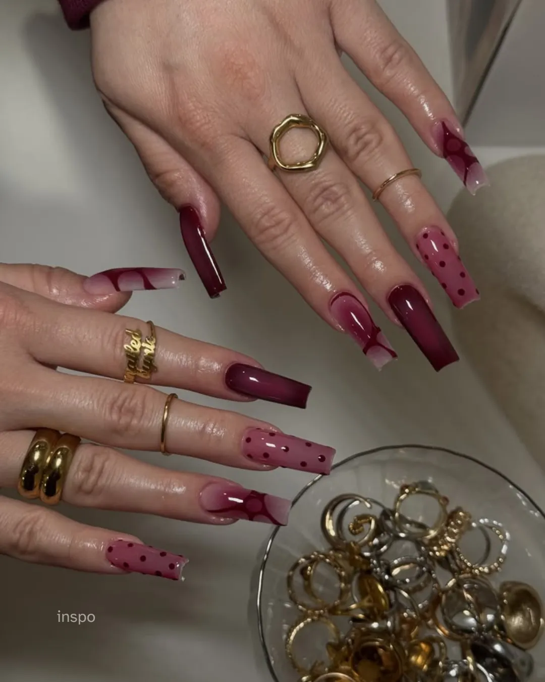 Long burgundy square nails mixed with pink dotted and decorative accents