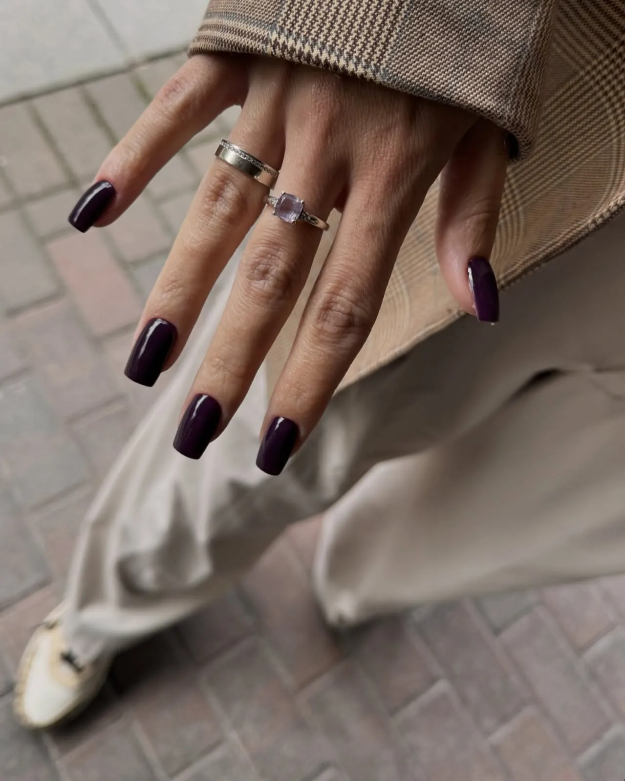 Short square nails in a dark plum burgundy shade