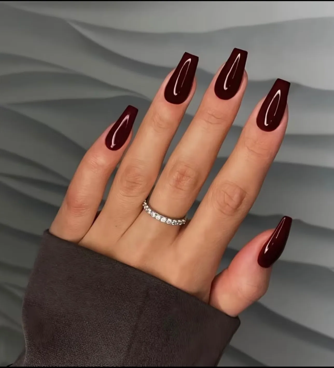 Long tapered square nails painted dark glossy burgundy