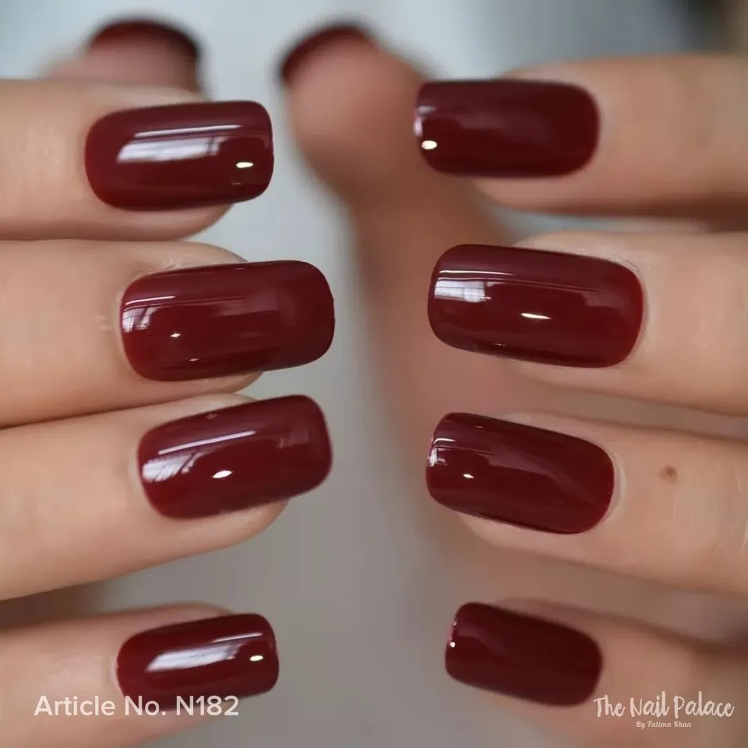 Burgundy nails with softened square corners and a glossy finish