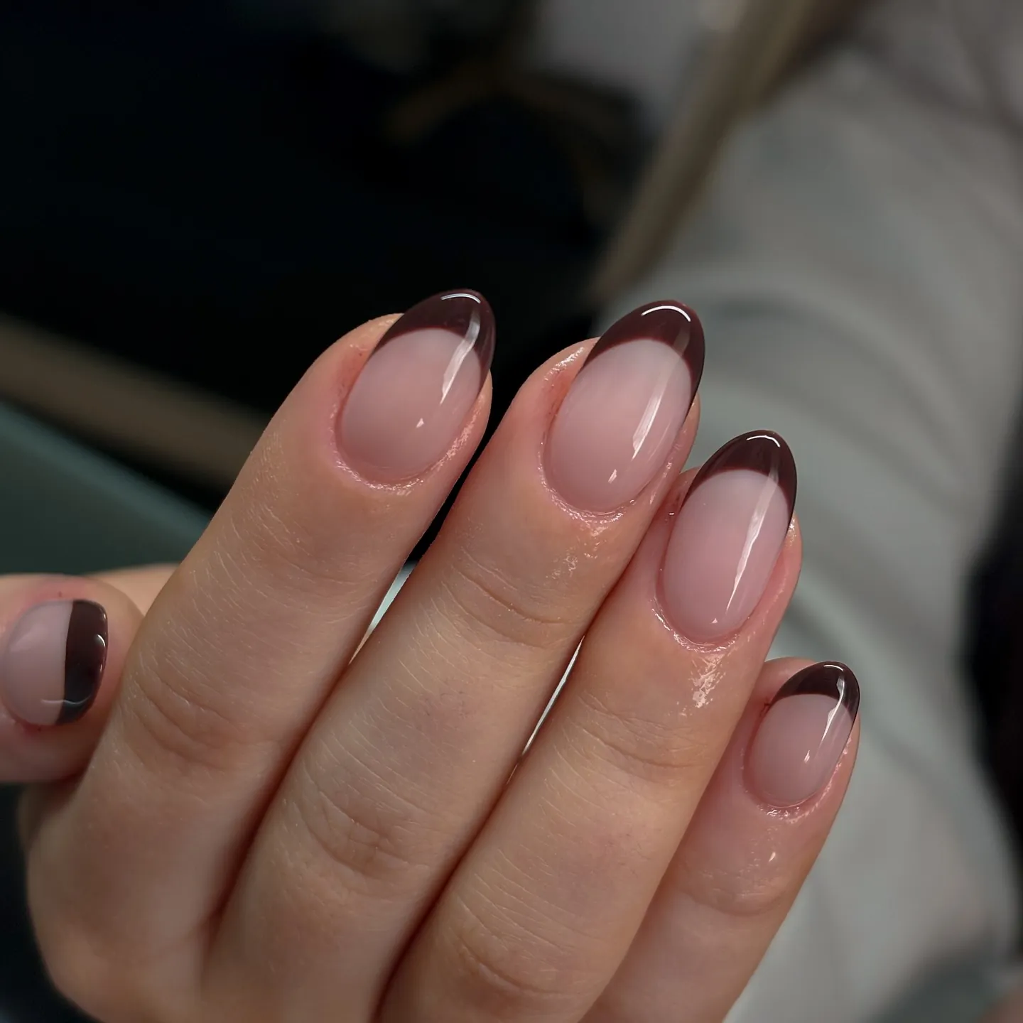Short pink rounded nails with narrow dark brown tips