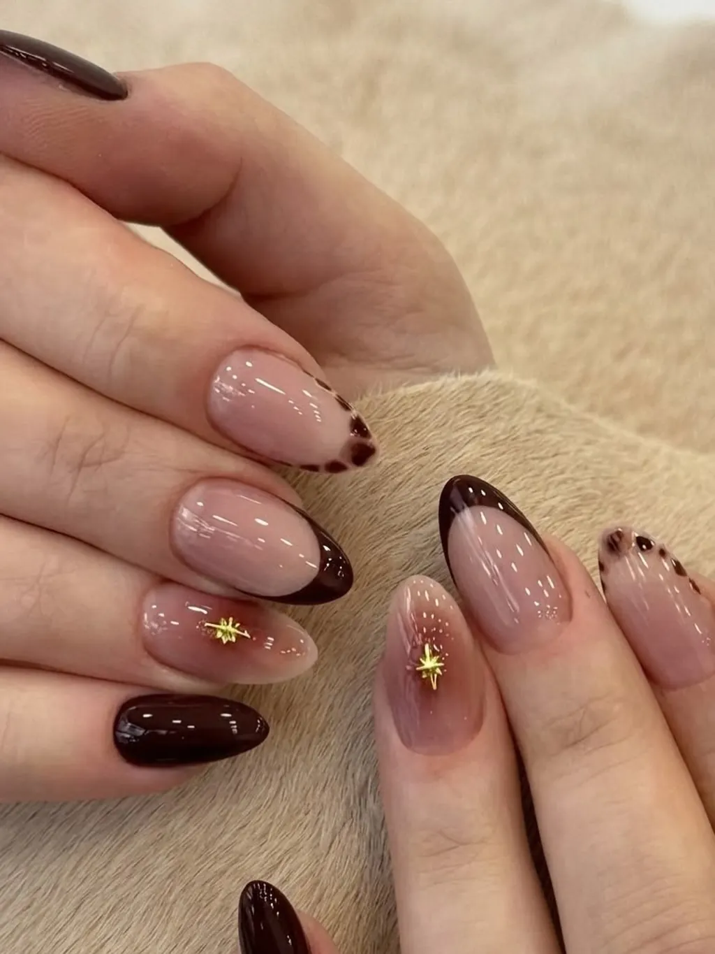 Brown French tips with dotted details and tiny gold star accents