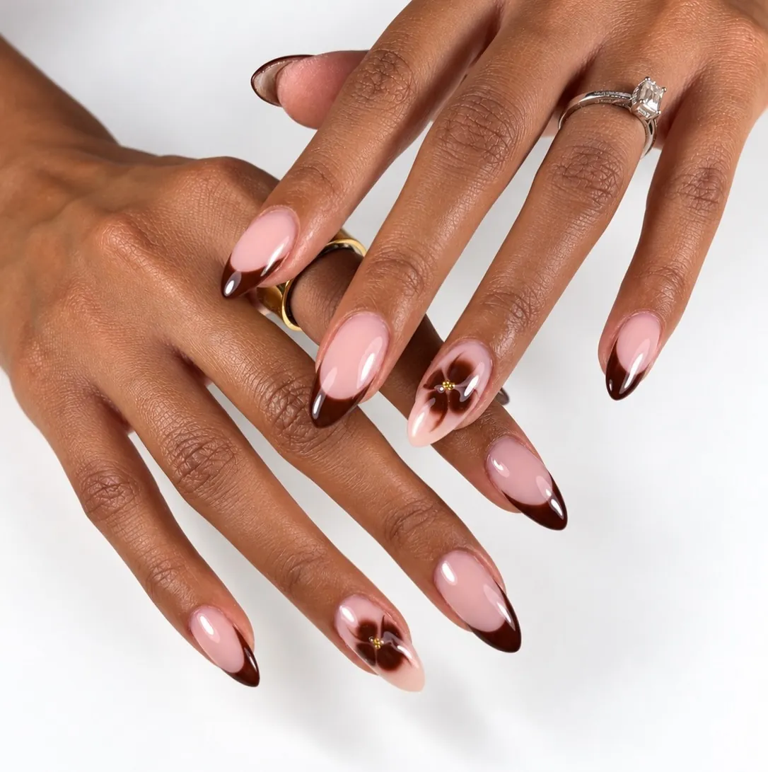 Pink almond nails with brown French tips and brown flower accents