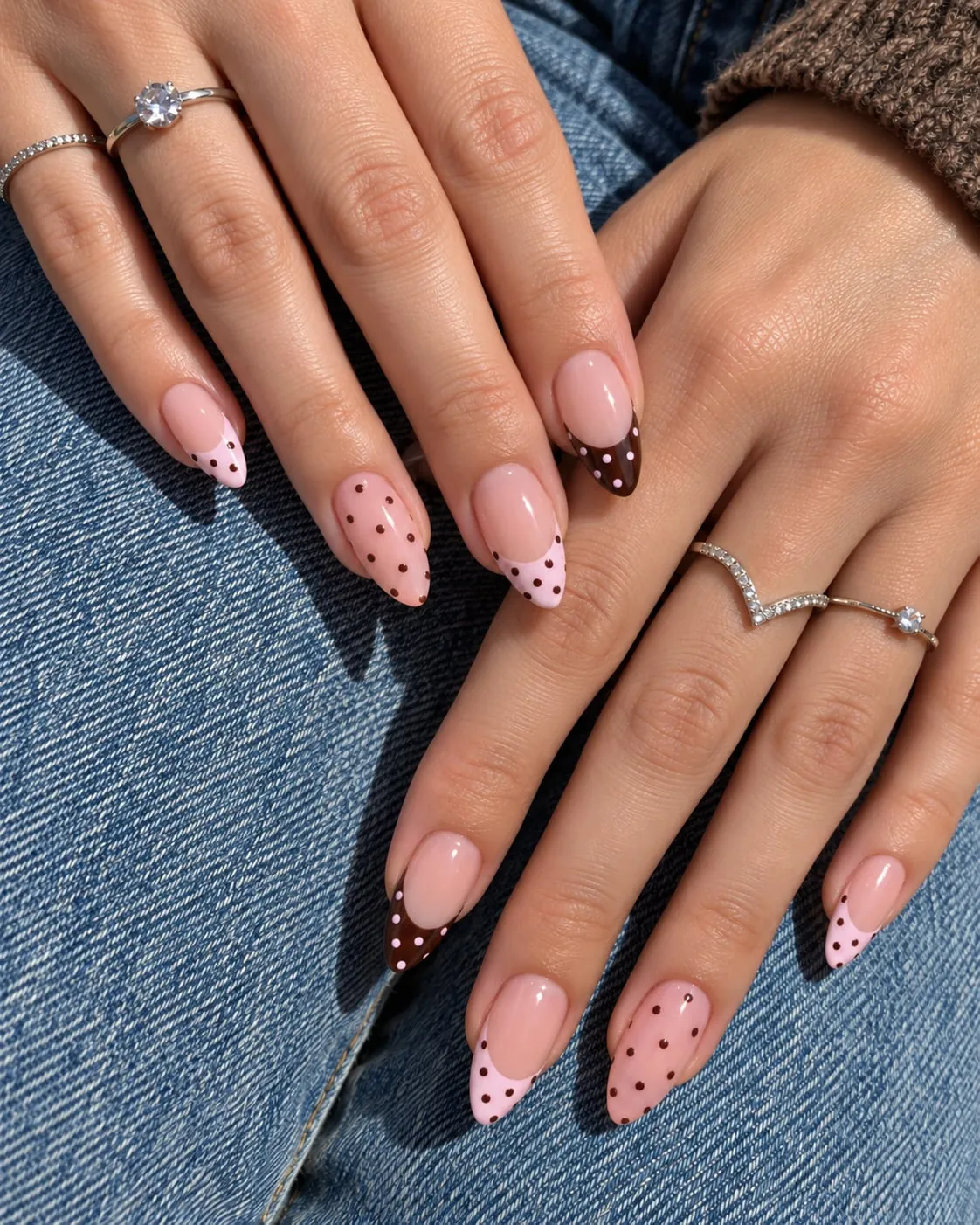 Pink almond nails with mixed brown and pink dotted French tips