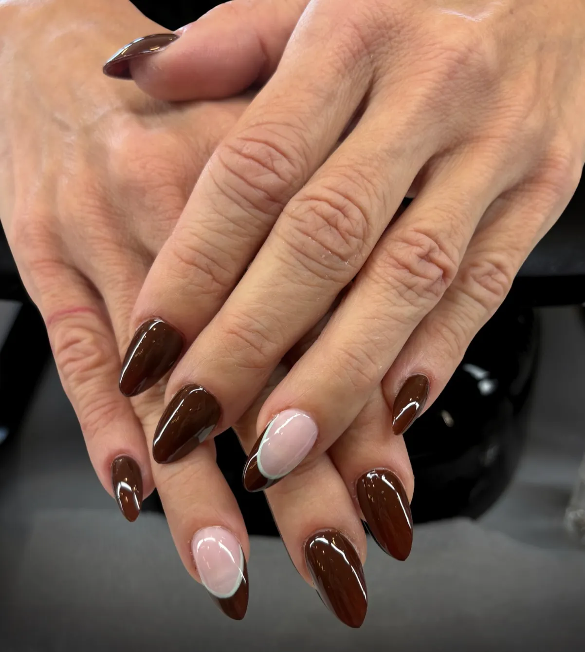 Solid brown almond nails with pale outlined French accent nails