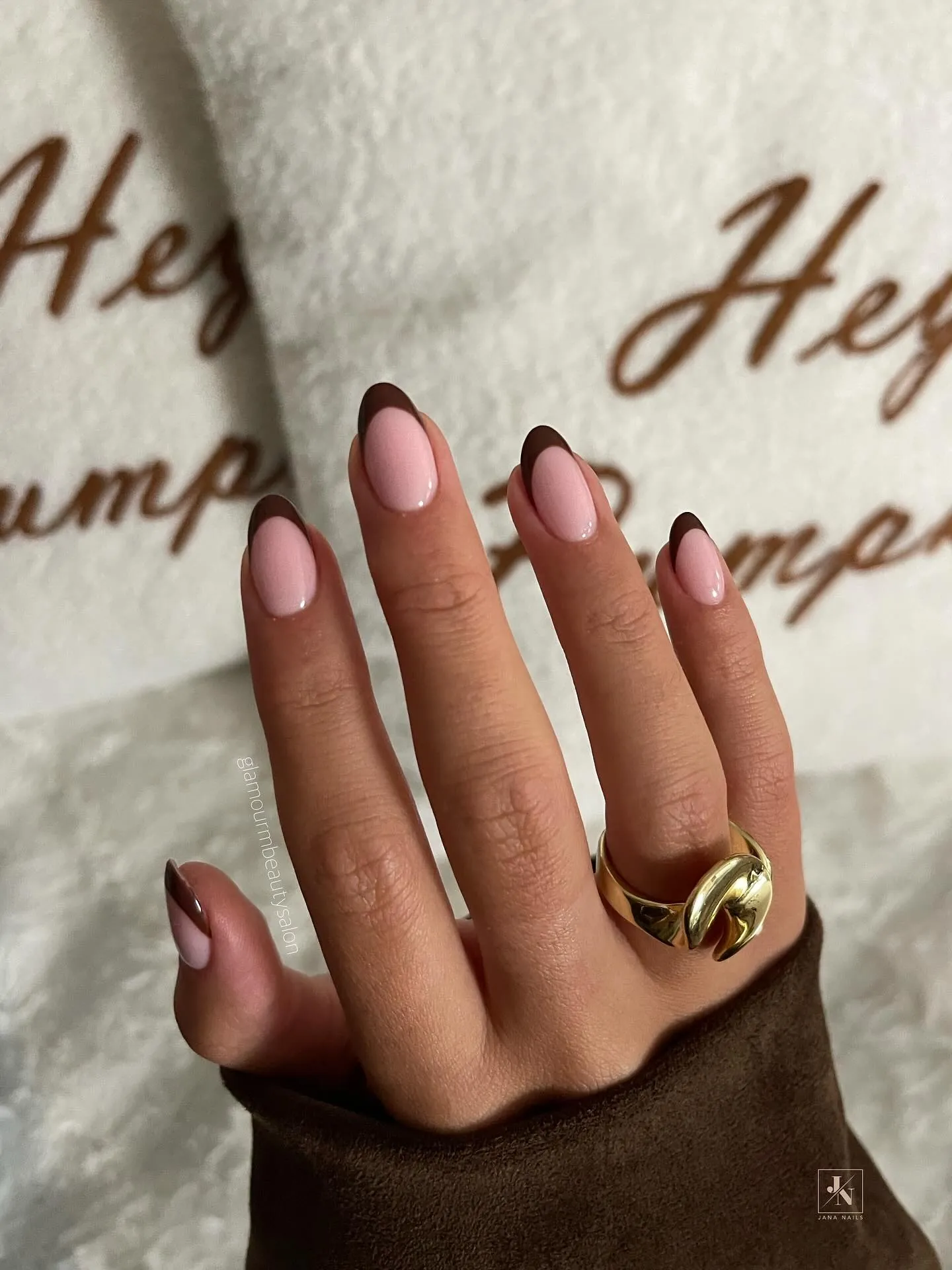 Pale pink almond nails edged with narrow dark brown tips