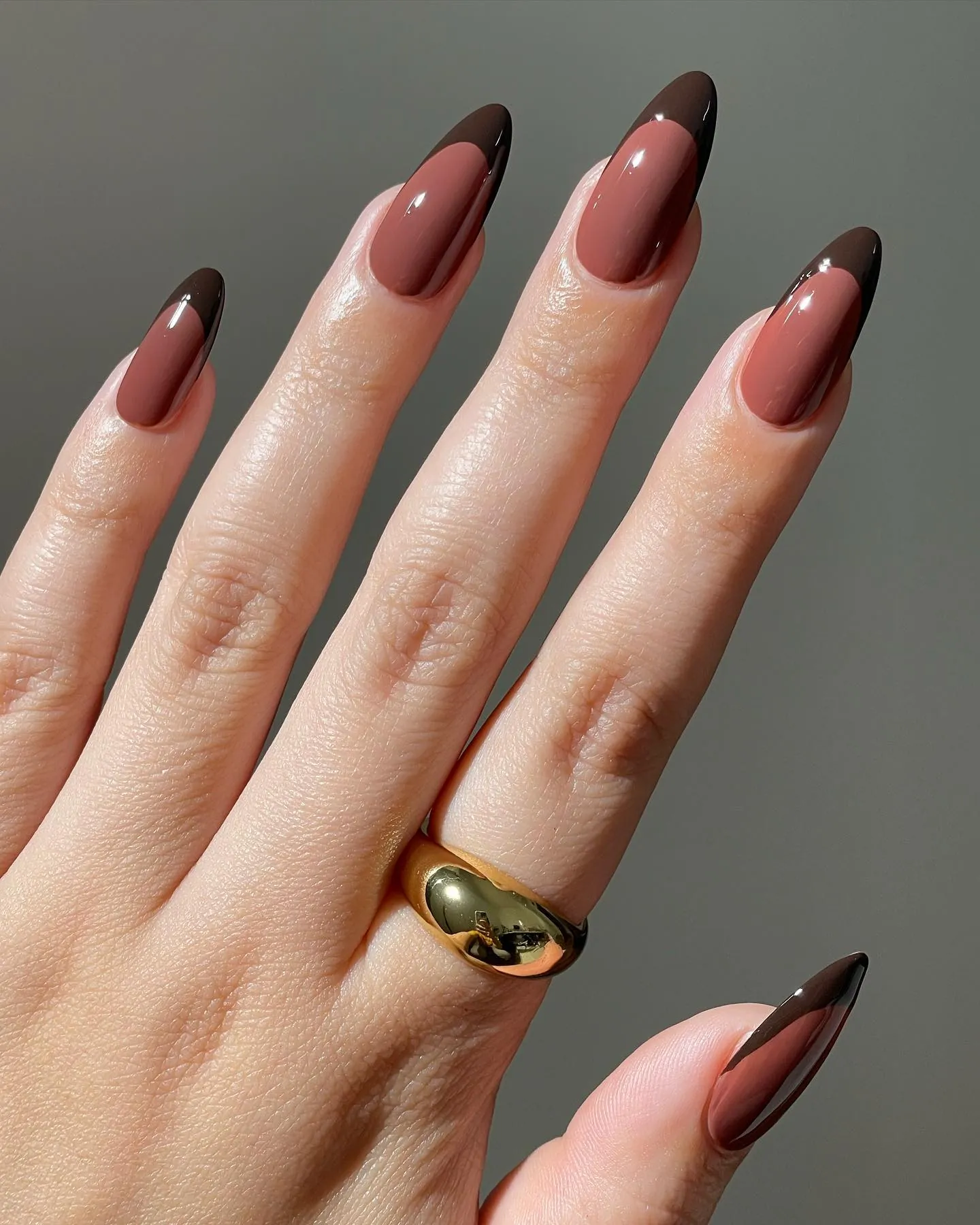 Pink almond nails with deep brown French tips