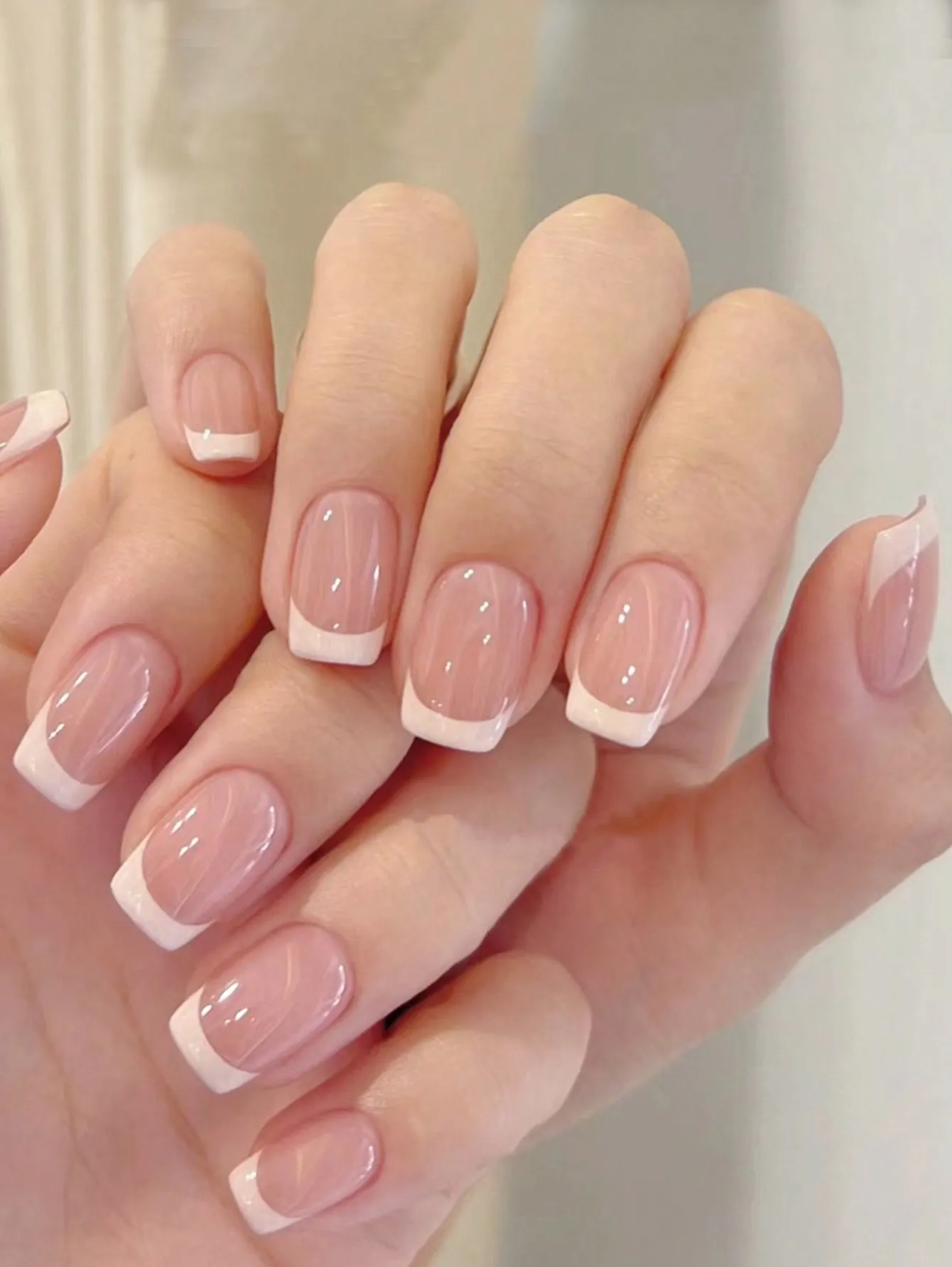 Glossy pink square nails with white French bands