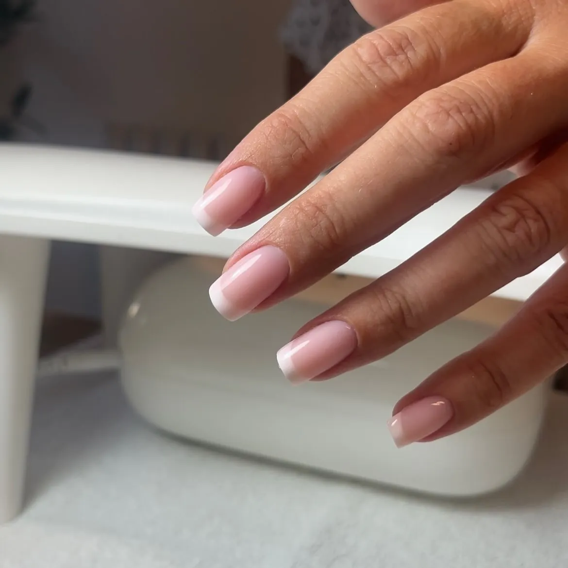 Pale pink square nails with fine white edges