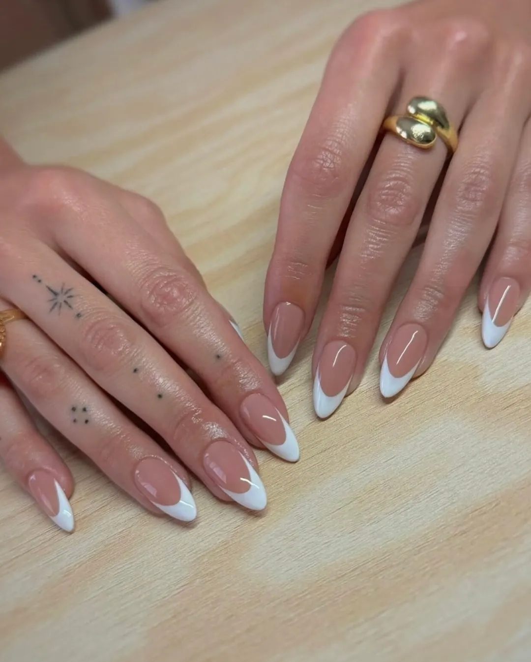 Pink almond nails with deep curved white French tips