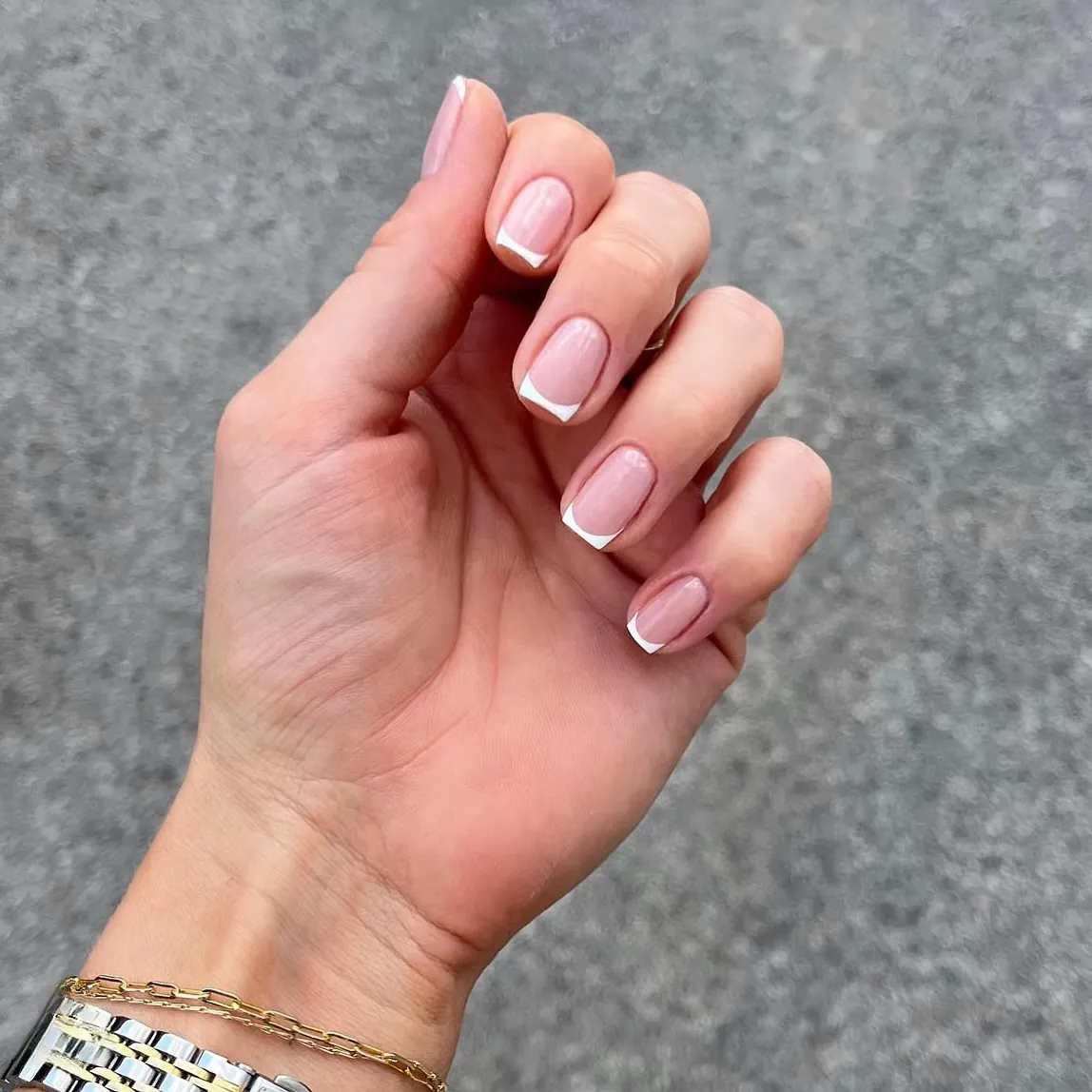 Short pink nails with very narrow white French borders
