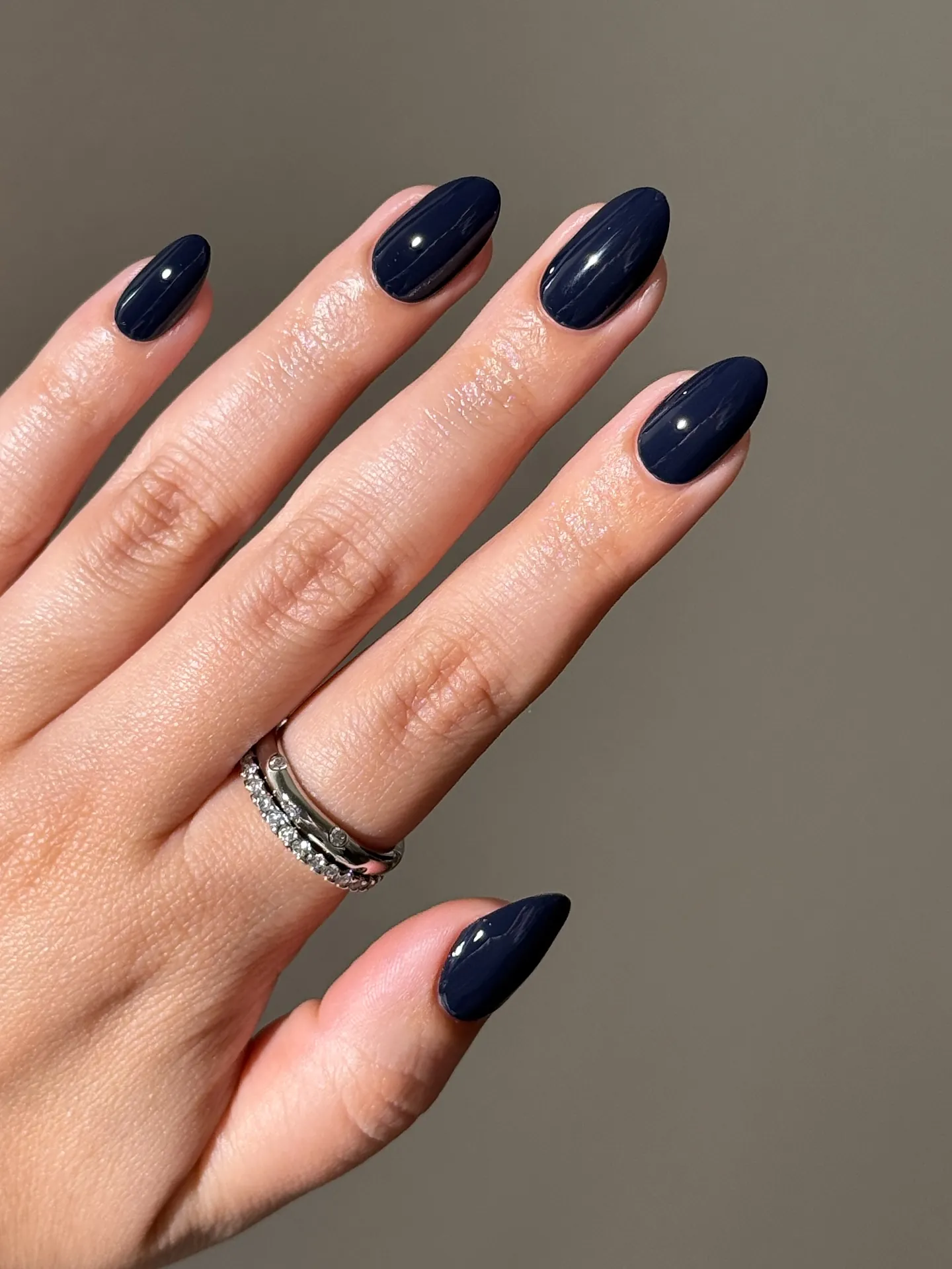 glossy navy almonds manicure