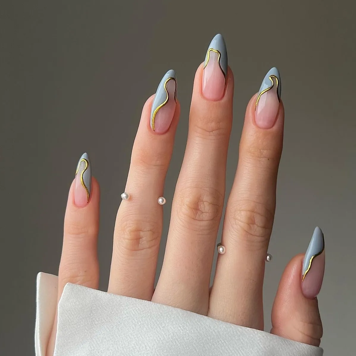 Blue grey almond French tips edged with curved gold lines