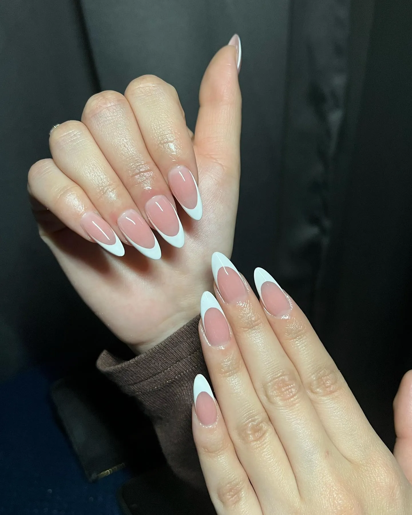 Long sheer pink almond nails with crisp white tips