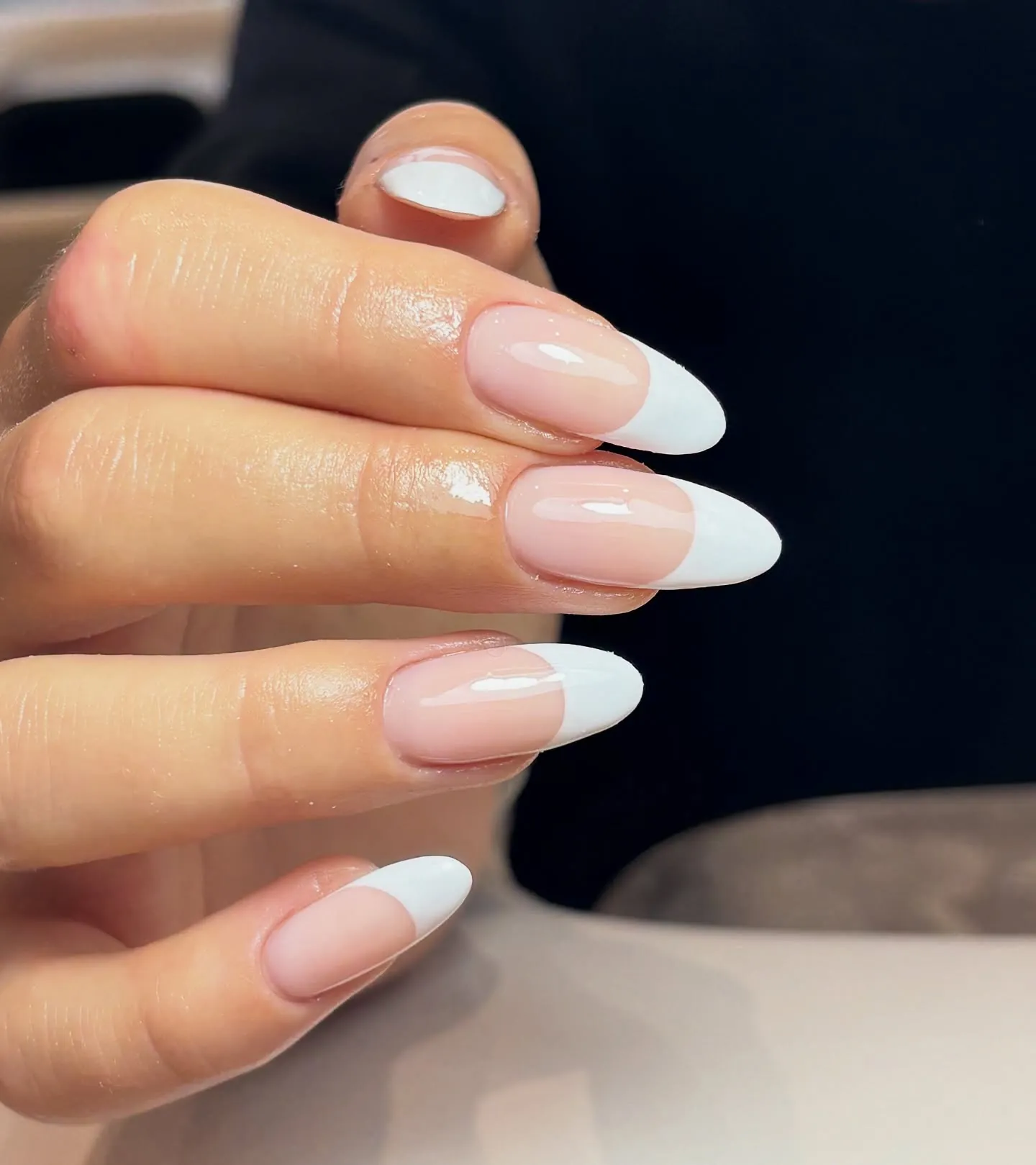 Pink rounded almond nails with broad opaque white tips