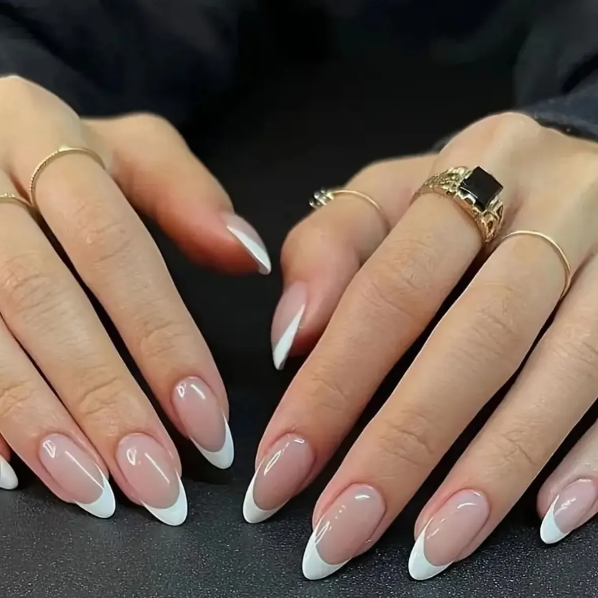 Nude almond nails with even narrow white French tips