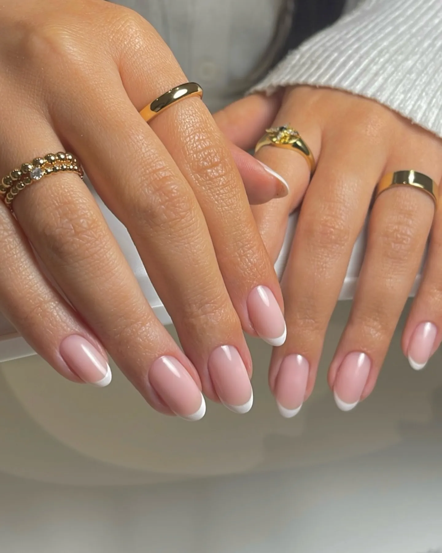 Short pink almond nails with fine white French tips